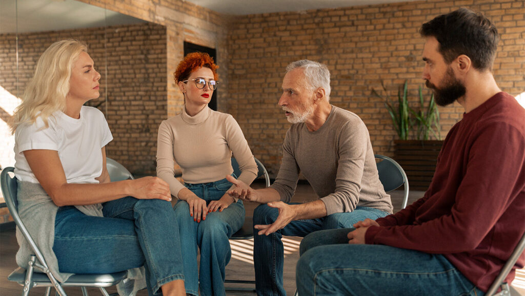 A diverse group of people participating in a mental health support group session.