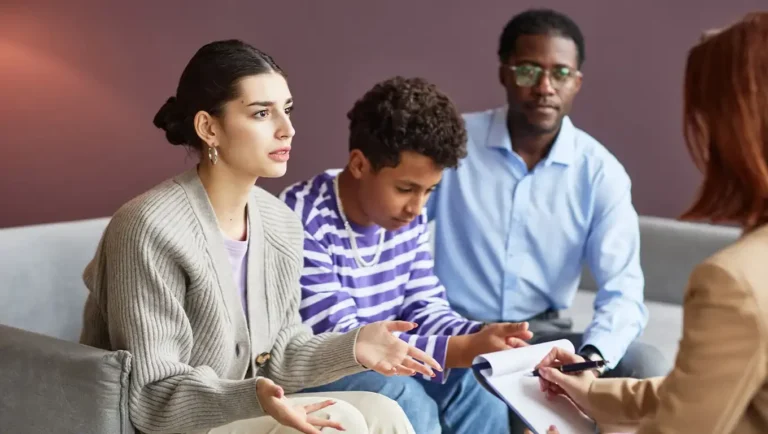 A family participates in a counseling session with a therapist.