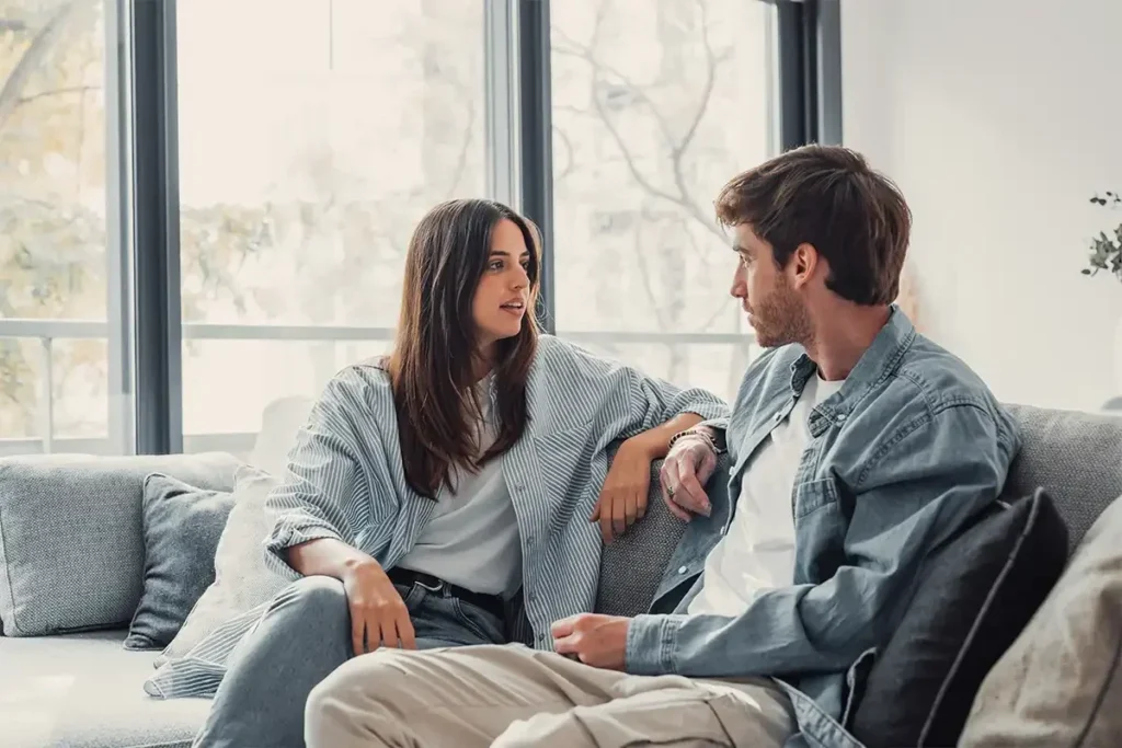 "A couple having a serious discussion on a couch."