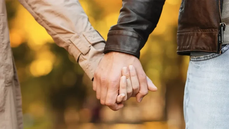 "A supportive couple holding hands."